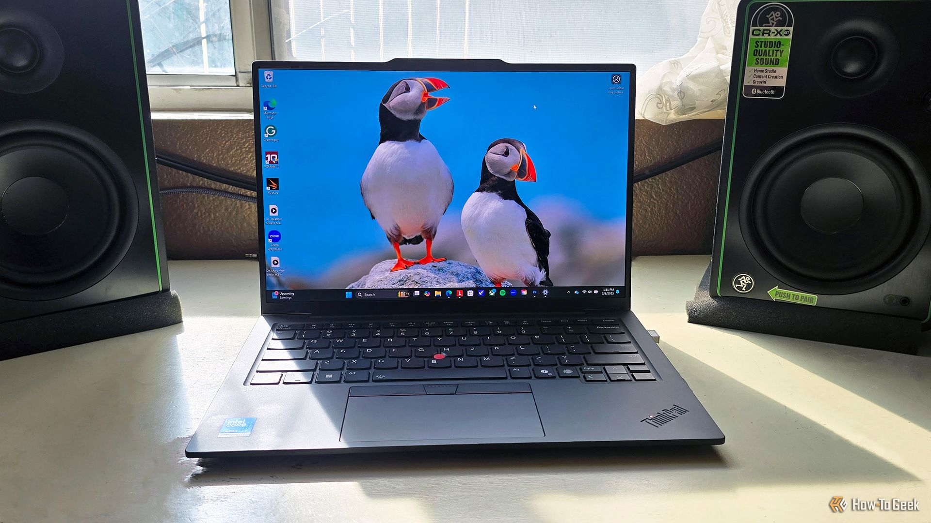 The Lenovo ThinkPad X1 Carbon Gen 13 Aura Edition laptop open on a desk.