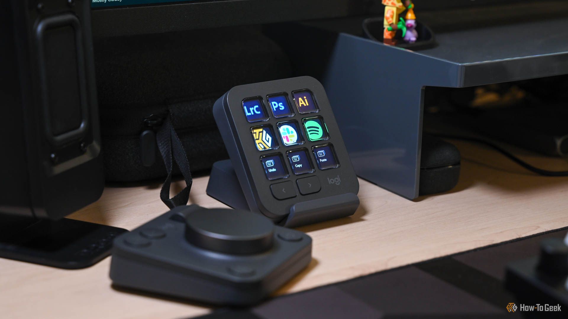 The MX Creative Keypad on its stand next to the MX Creative Dialpad.