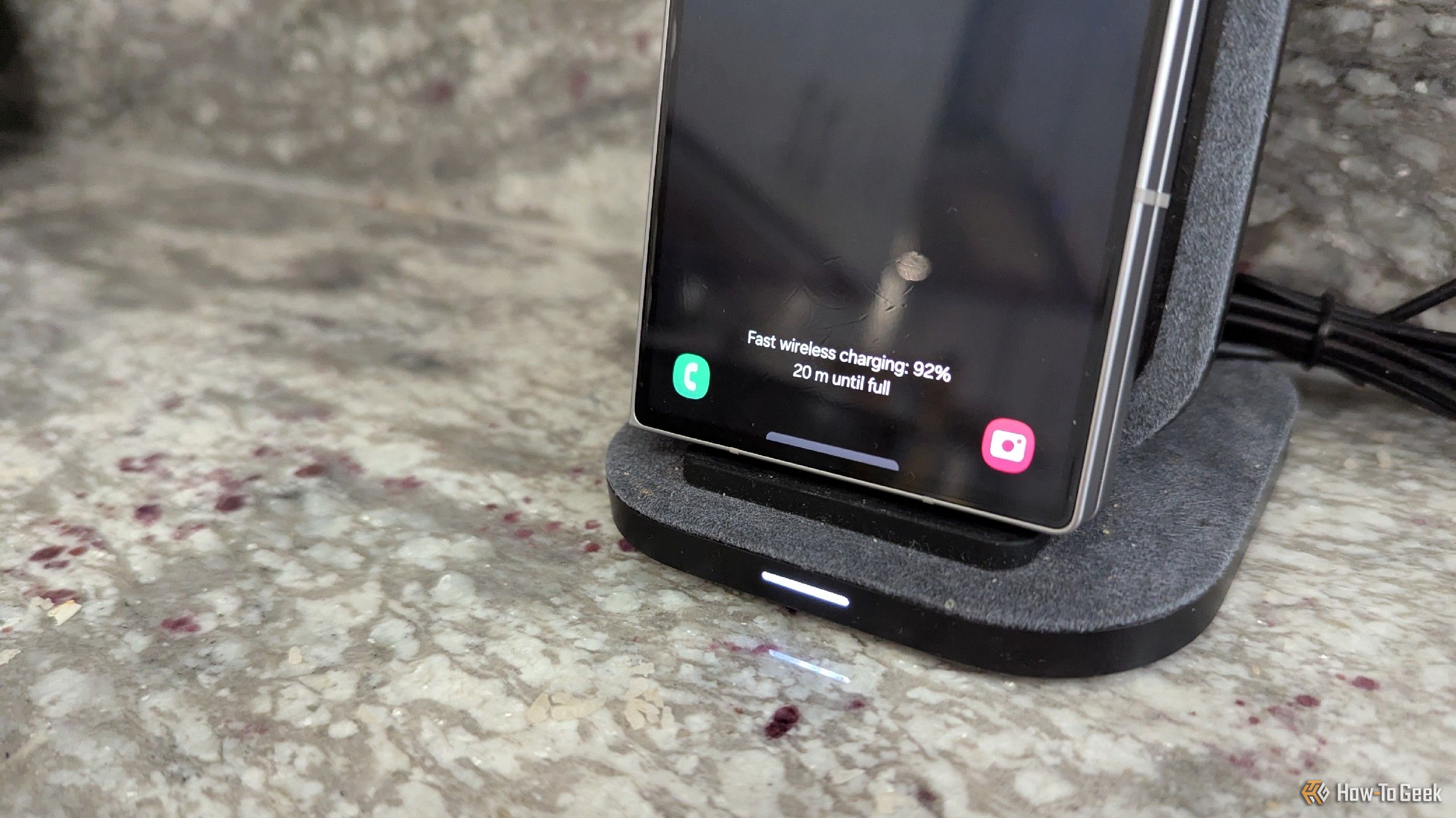 Samsung Galaxy Z Fold 6 on an upright wireless charger.