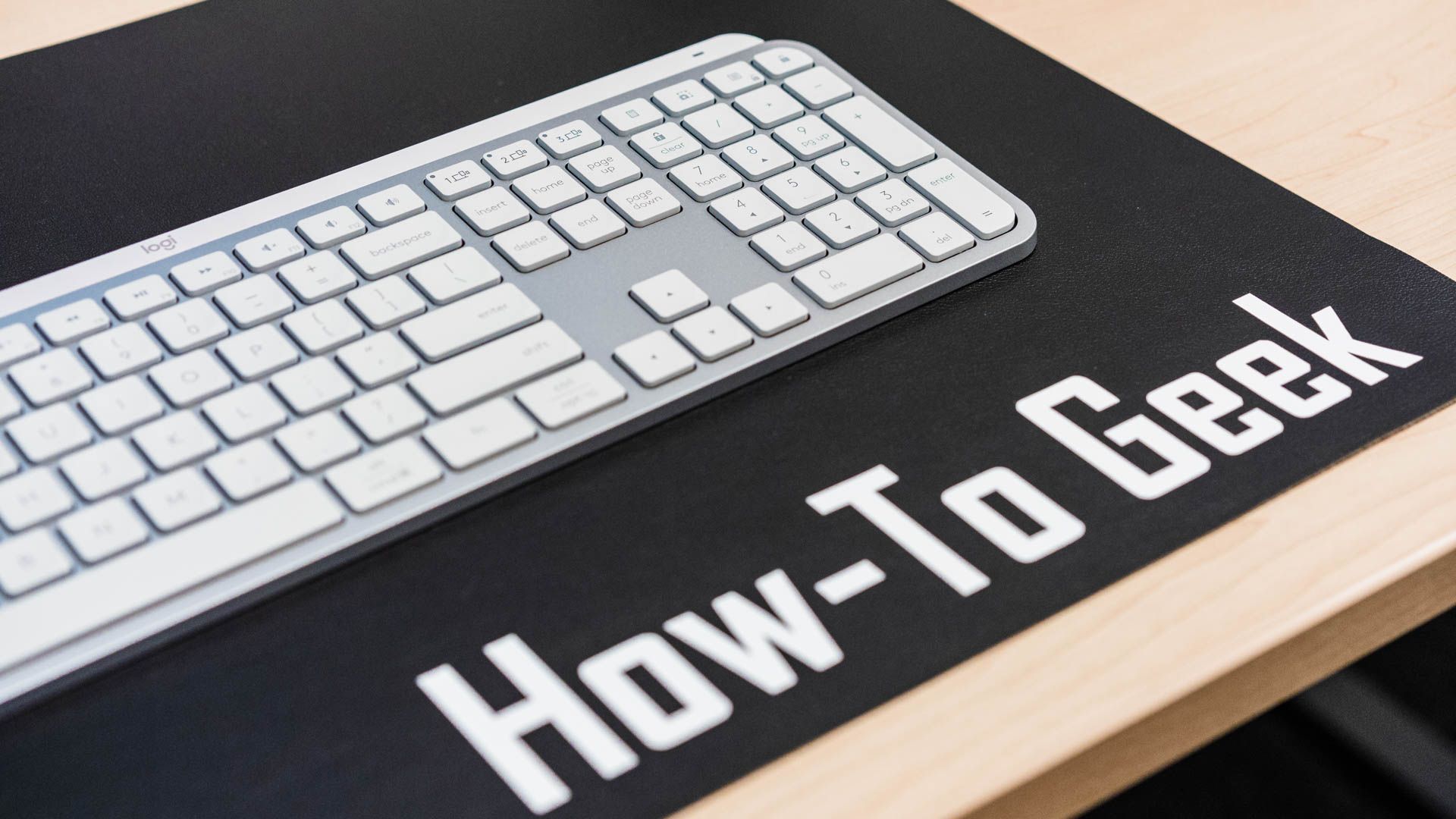 The Start key on the  Logitech MX Keys S keyboard on a HTG desk mat
