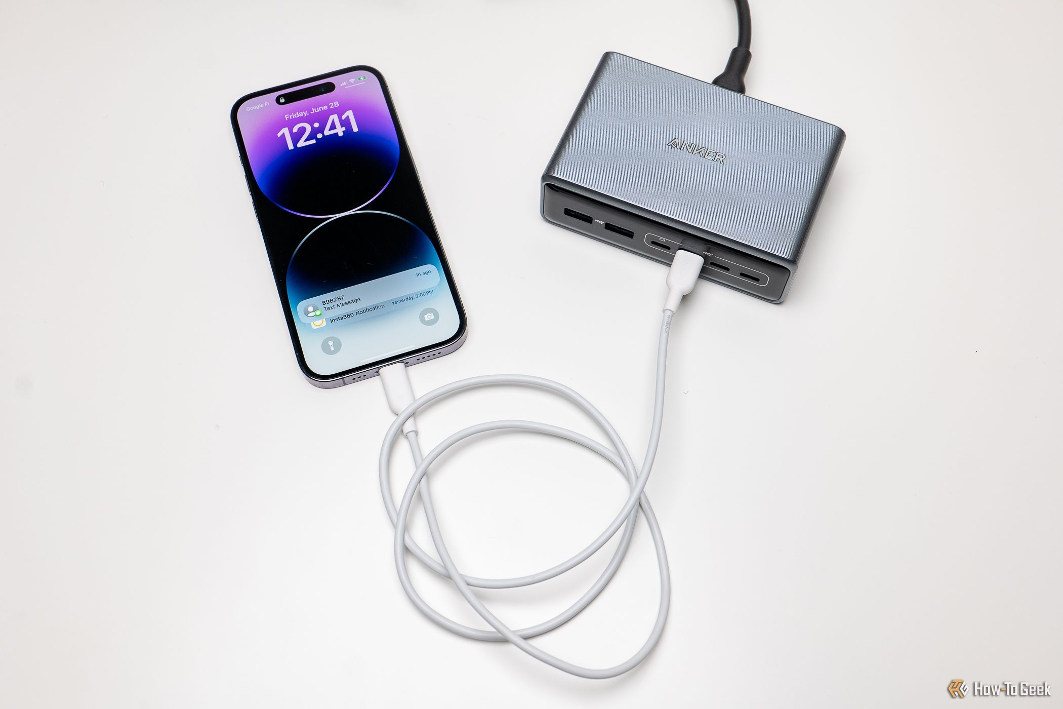 Anker Prime 6-in-1 Charger charging an iPhone.