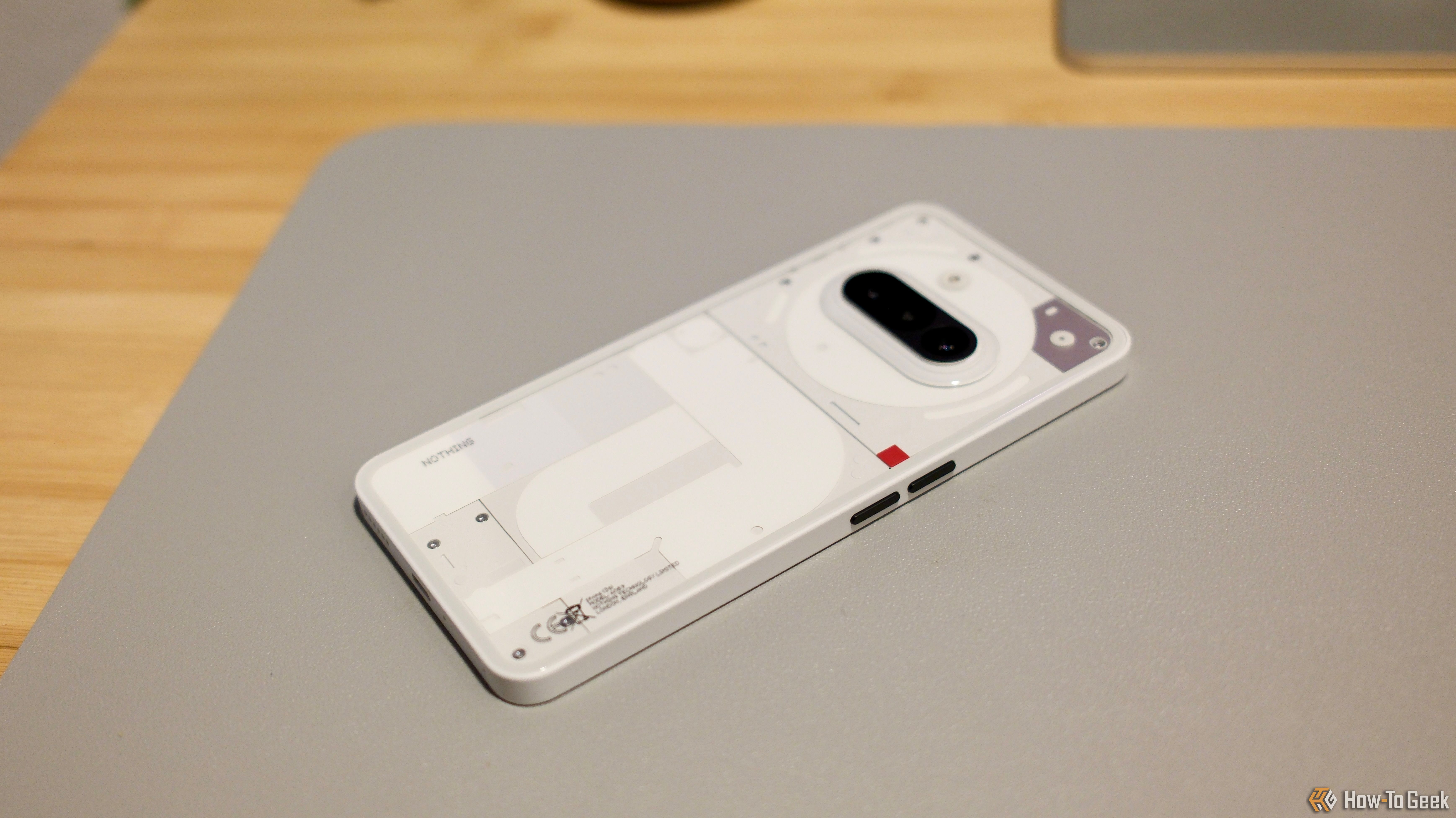 Nothing Phone (3a) in white on a desk.