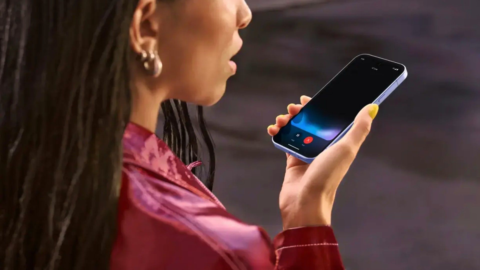 Google Pixel 9a in use by a woman who is speaking to it.