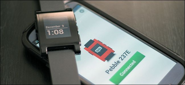 A Pebble watch on top of a smartphone