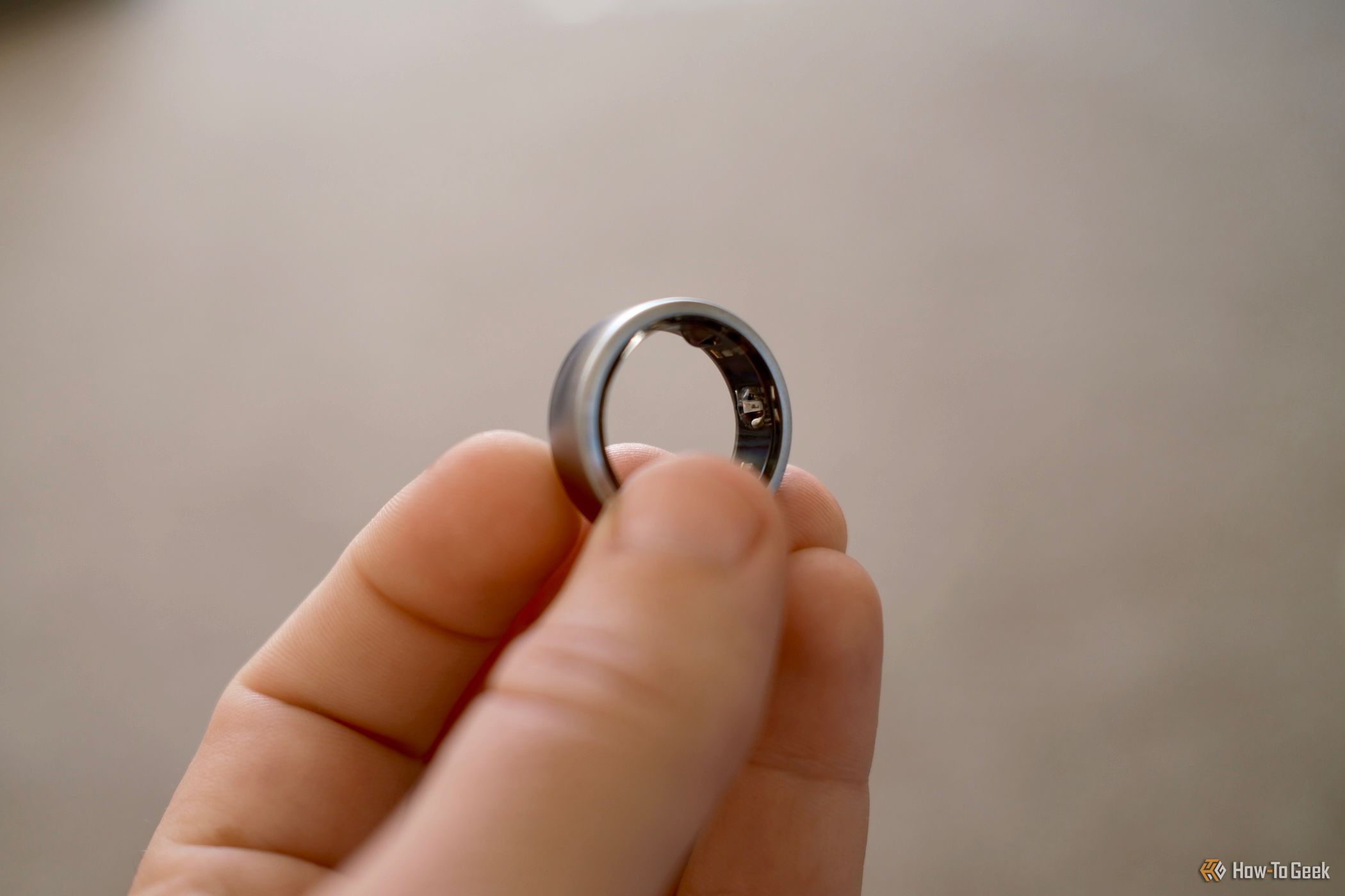 Oura Ring held in a hand