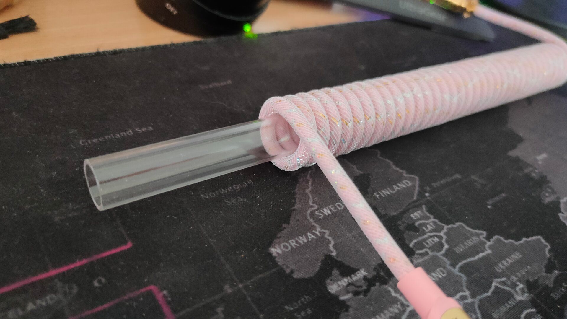 A plastic rod inside of a coiled keyboard cable.