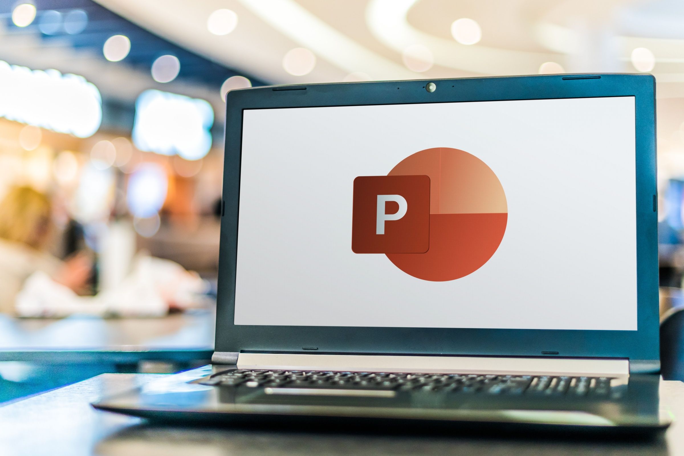 A PowerPoint logo open on a laptop.
