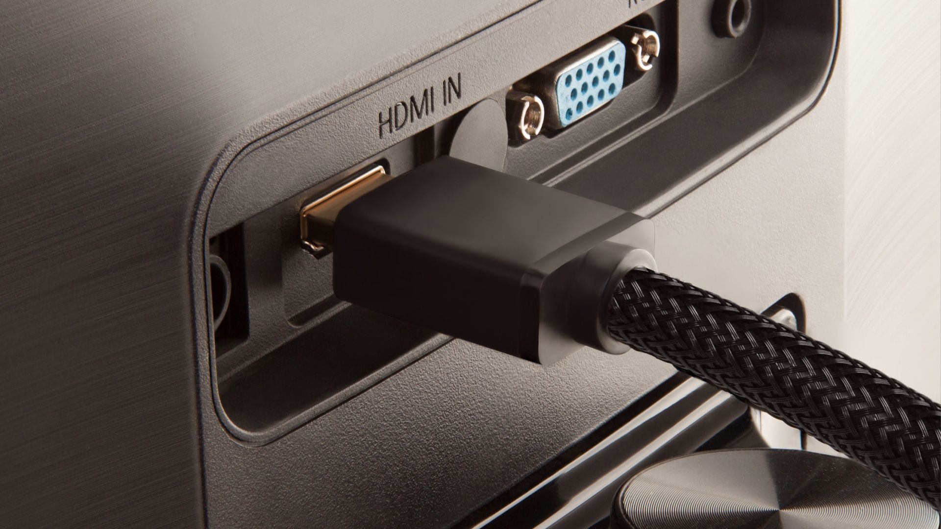 An HDMI cable plugged into the back of a monitor.