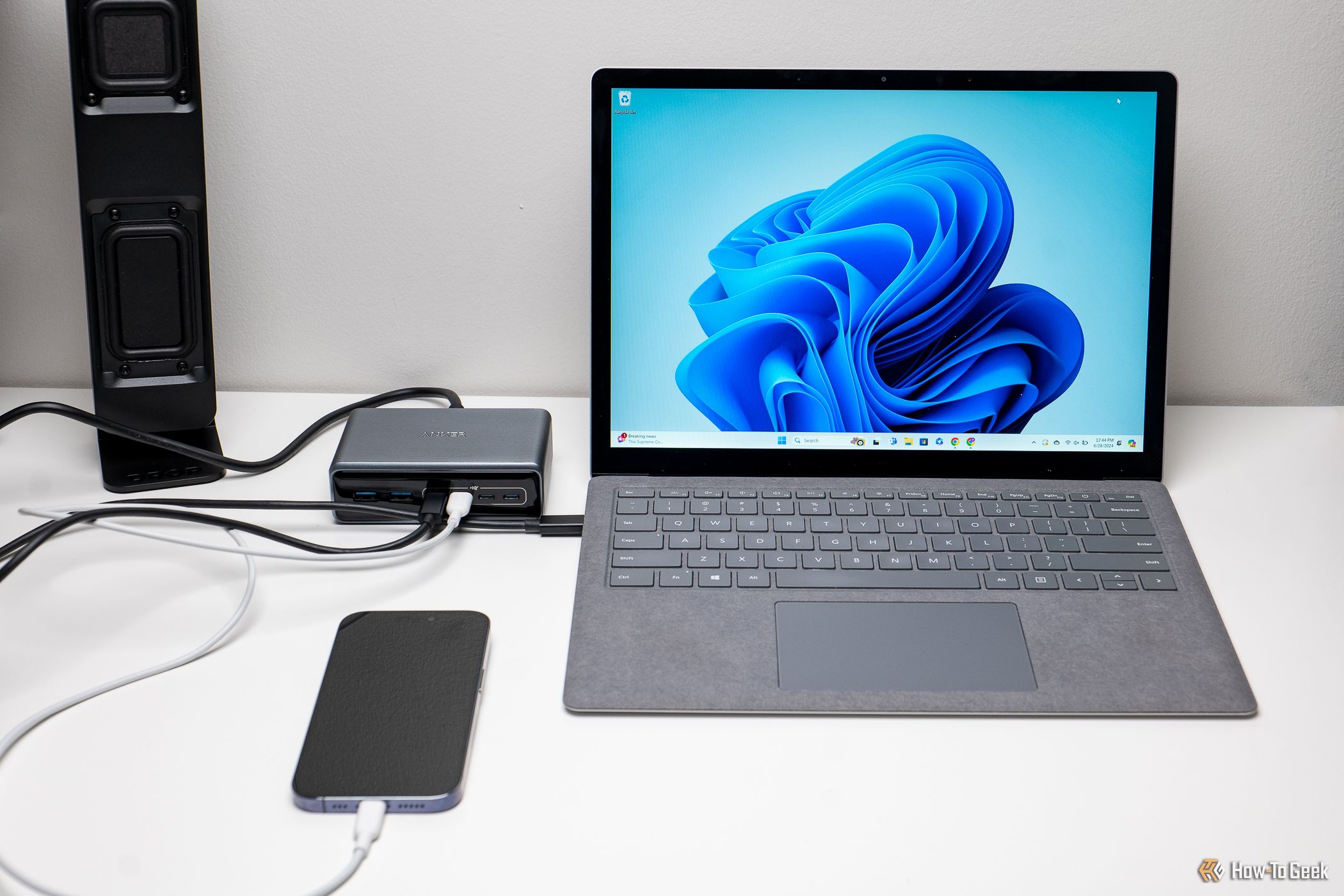 The Anker Prime 6-in-1 Charger connected to a laptop and iPhone.