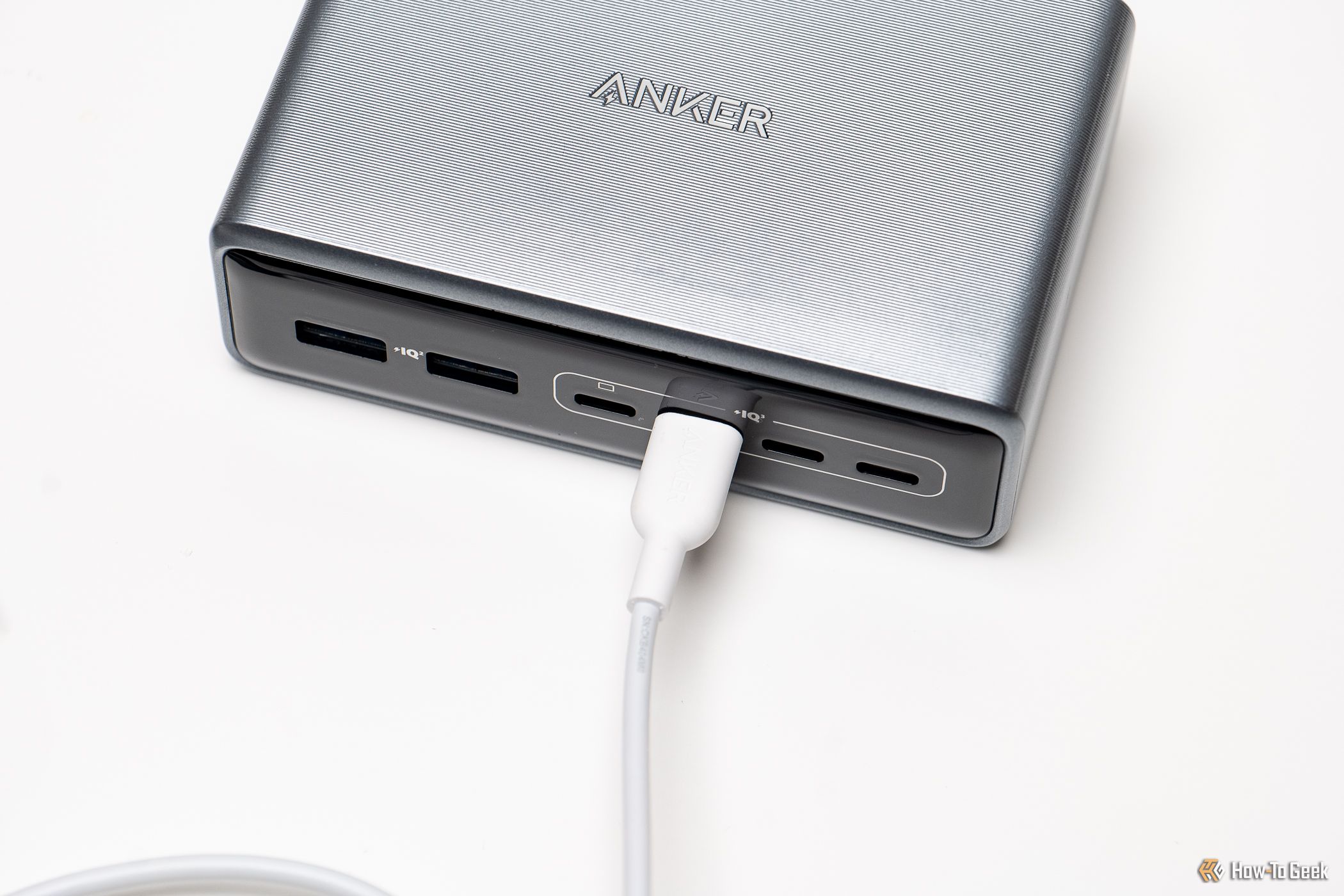 The Anker Prime 6-in-1 Charger with a charging cable connected.