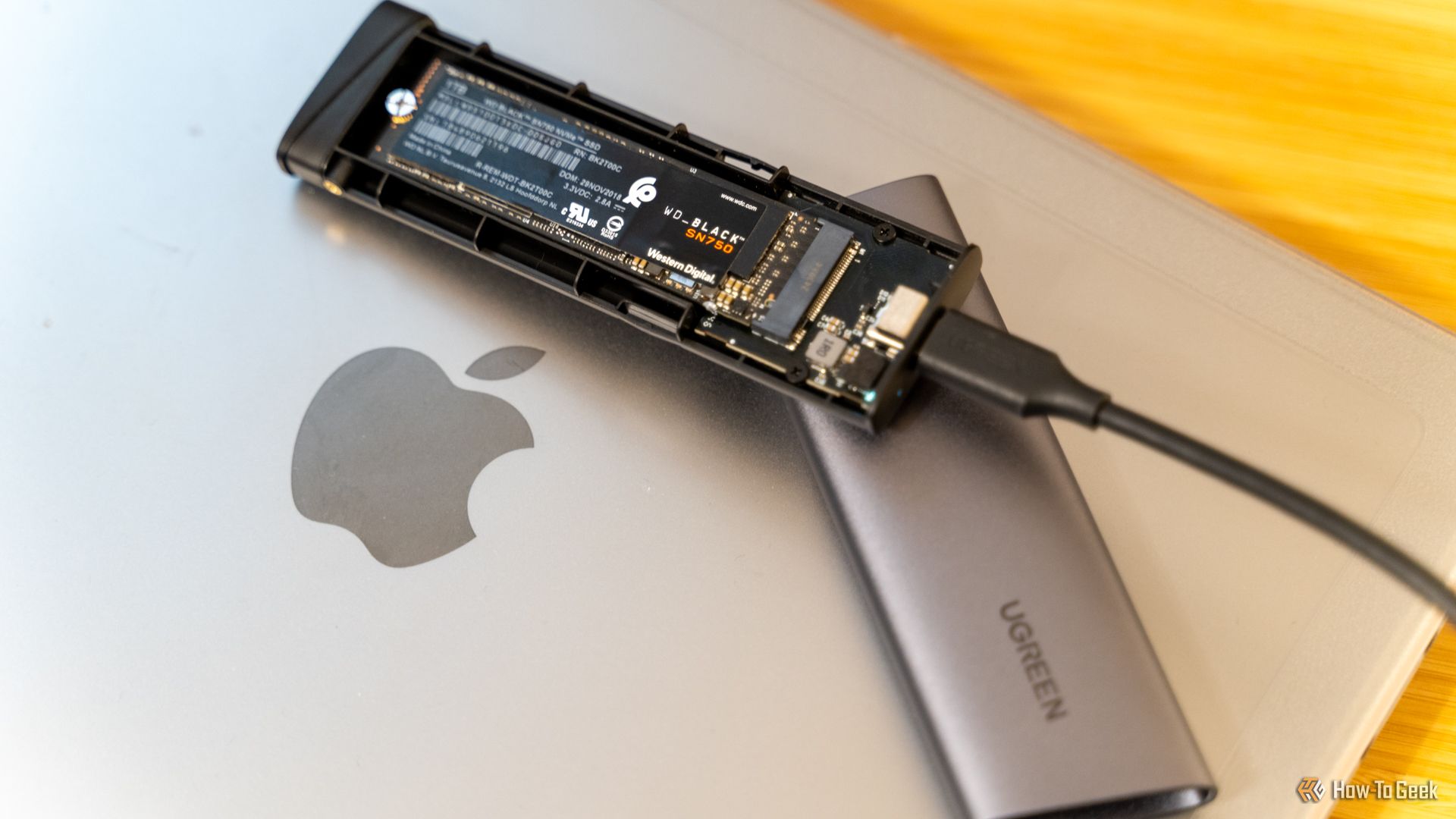UGREEN M.2 NVMe SSD USB-C Enclosure with WD_BLACK SN750 SSD Inside Sitting on a MacBook.