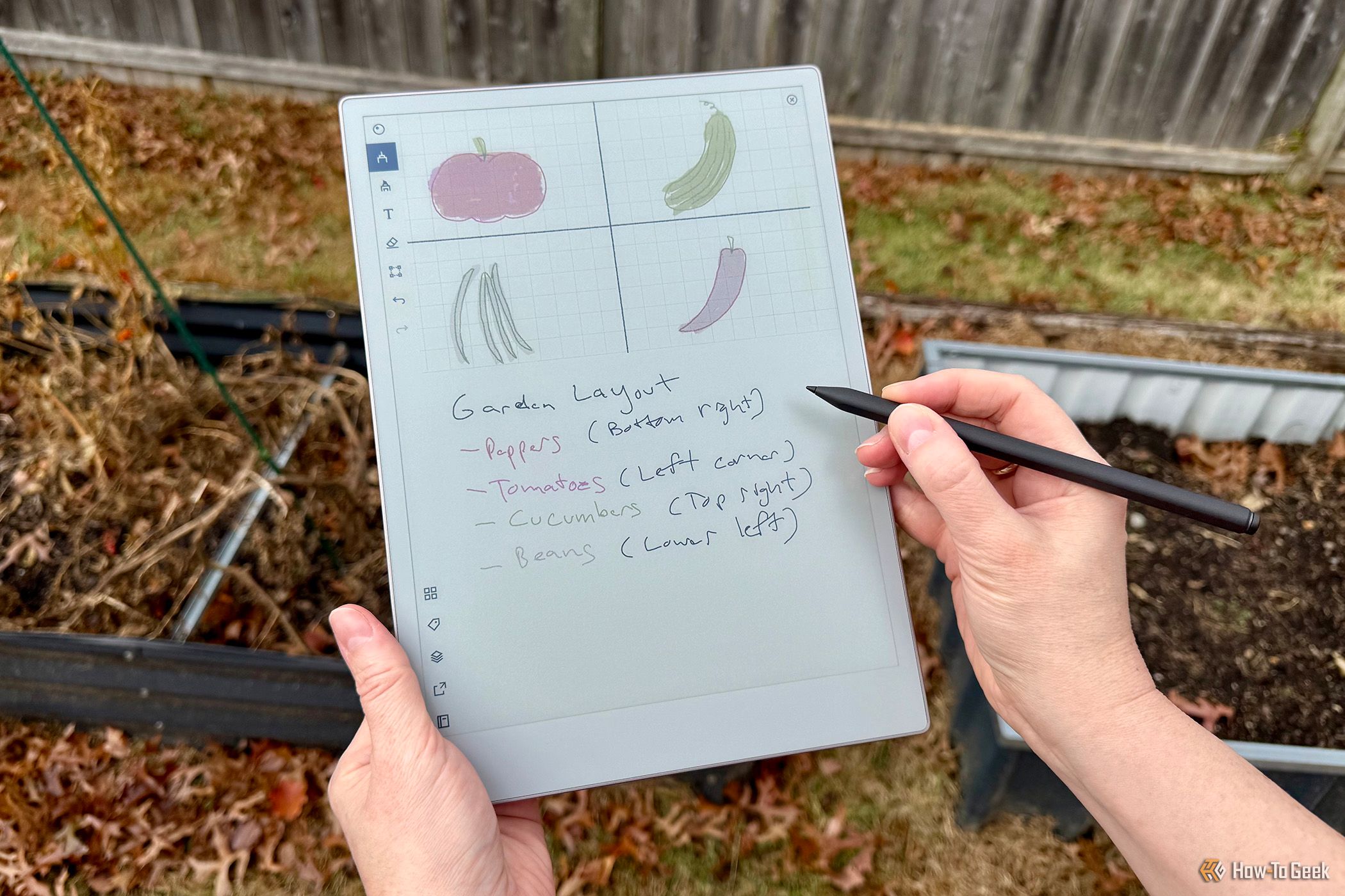 Hands holding and using the reMarkable Paper Pro outdoors