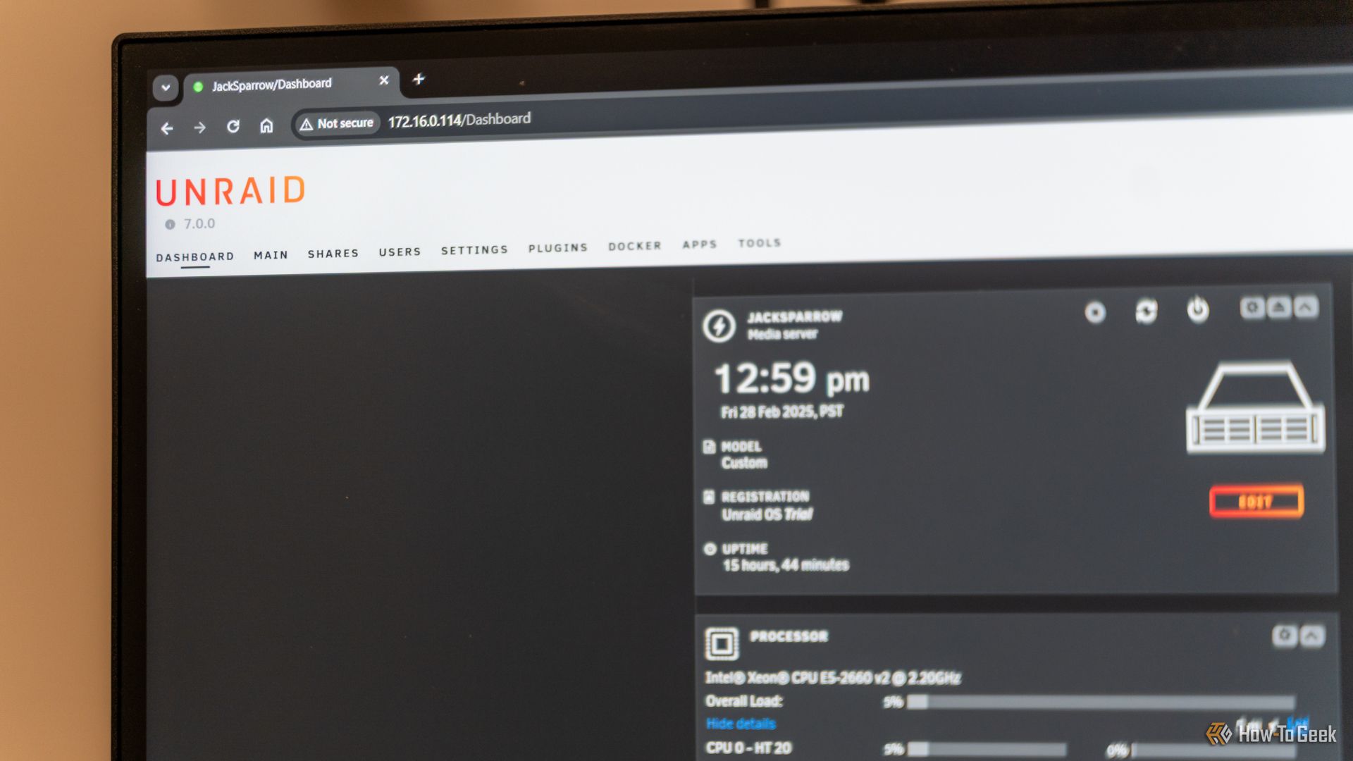 The Unraid dashboard opened on a computer monitor showing the logo and some server statistics.