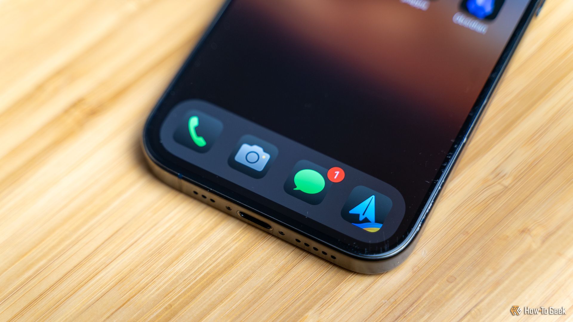The app dock of an iPhone with the phone, camera, messages, and Spark email app docked.