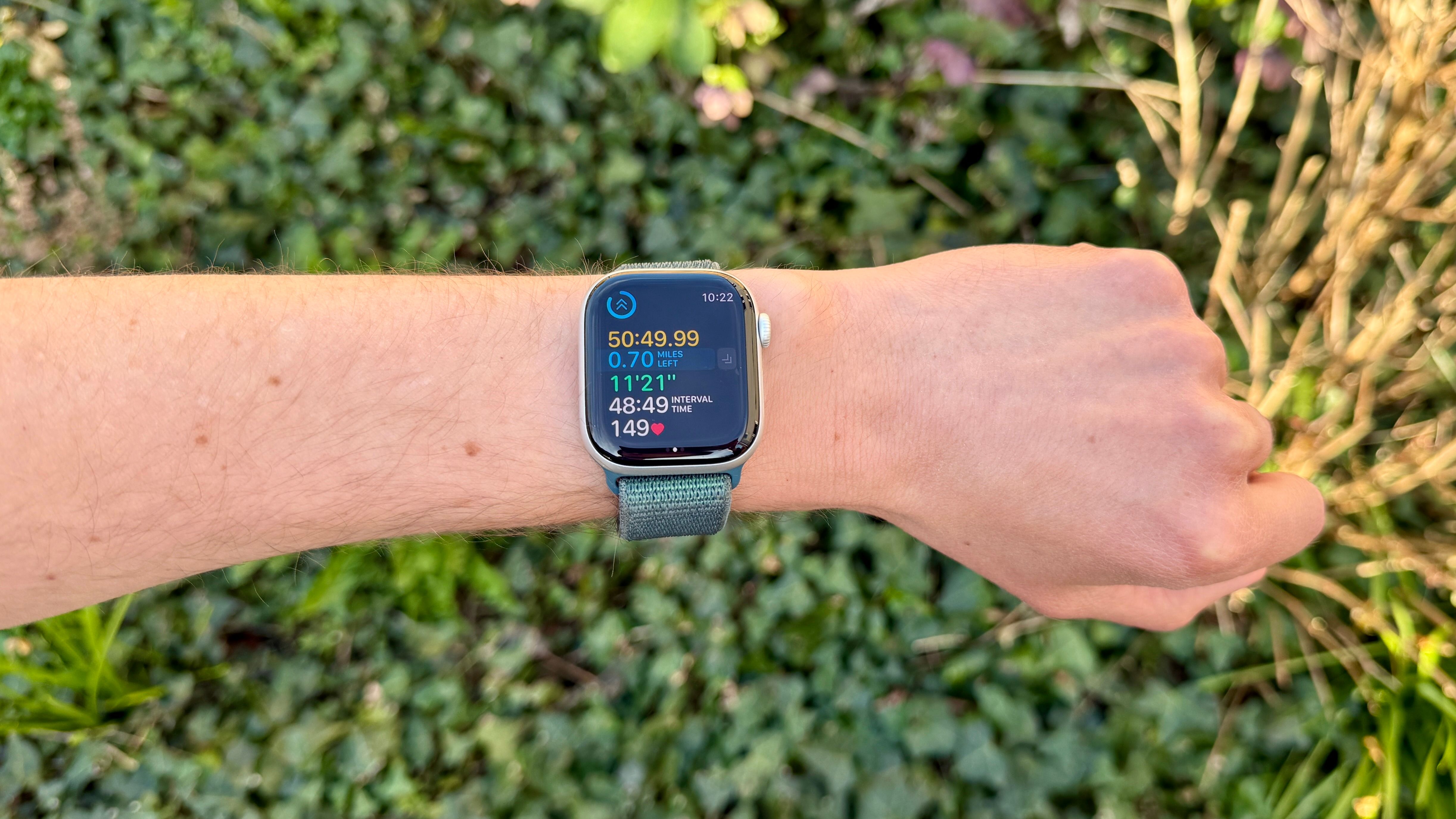 Apple Watch on a man's arm showing Outdoor Running interval.