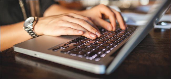 hands typing on a mac laptop