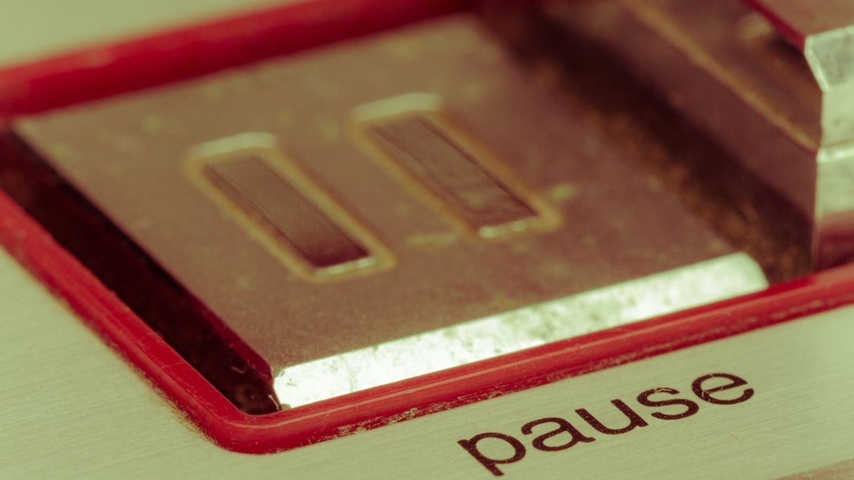 Close up of a pause button from an old-fashioned tape deck.