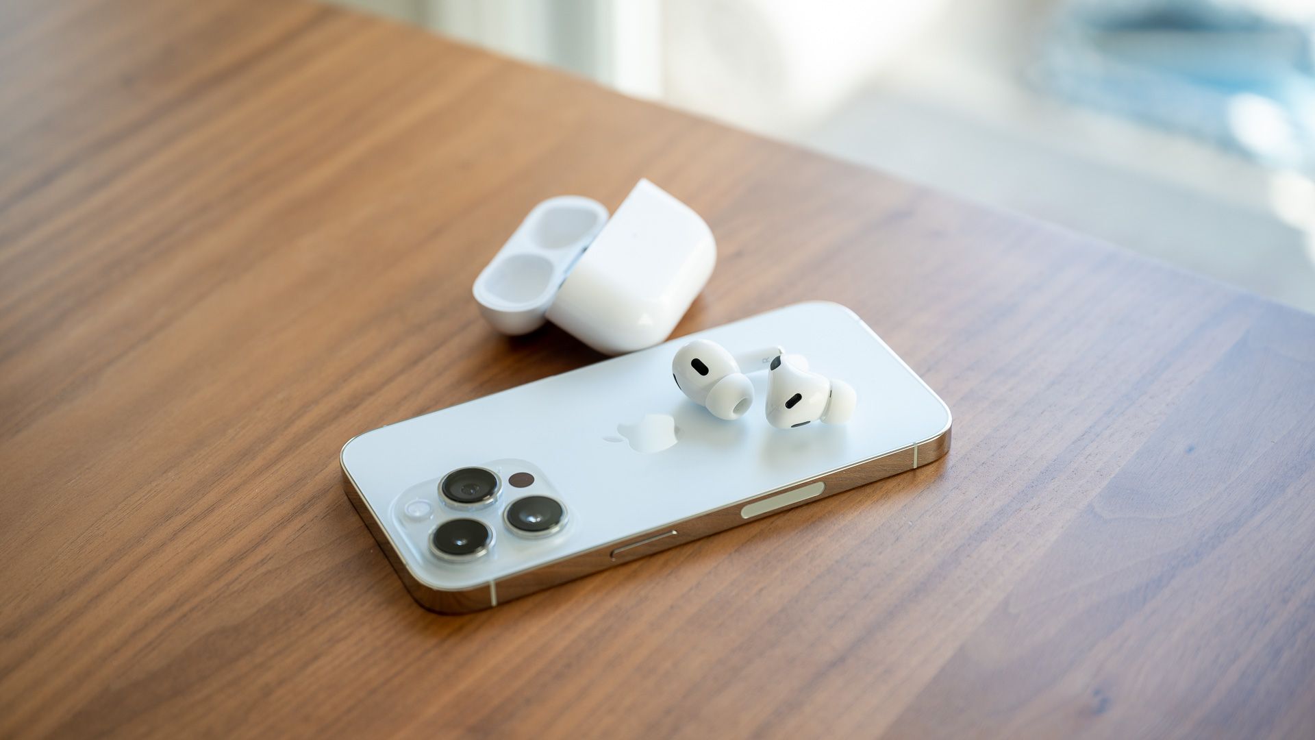 Apple AirPods Pro 2nd Gen sitting on the back of the iPhone 14 Pro.