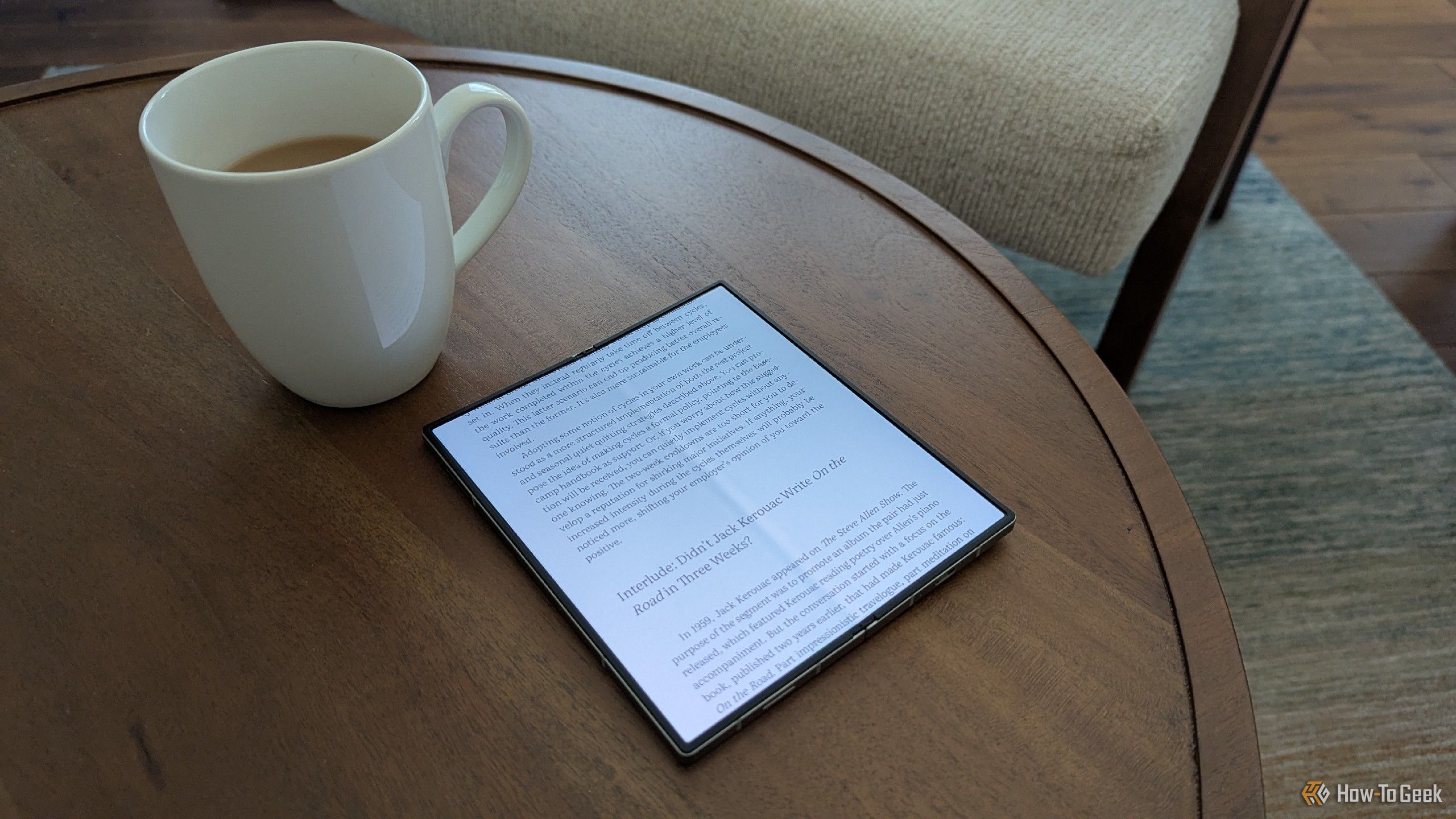 An eBook on a Galaxy Z Fold 6 next to a mug of tea.