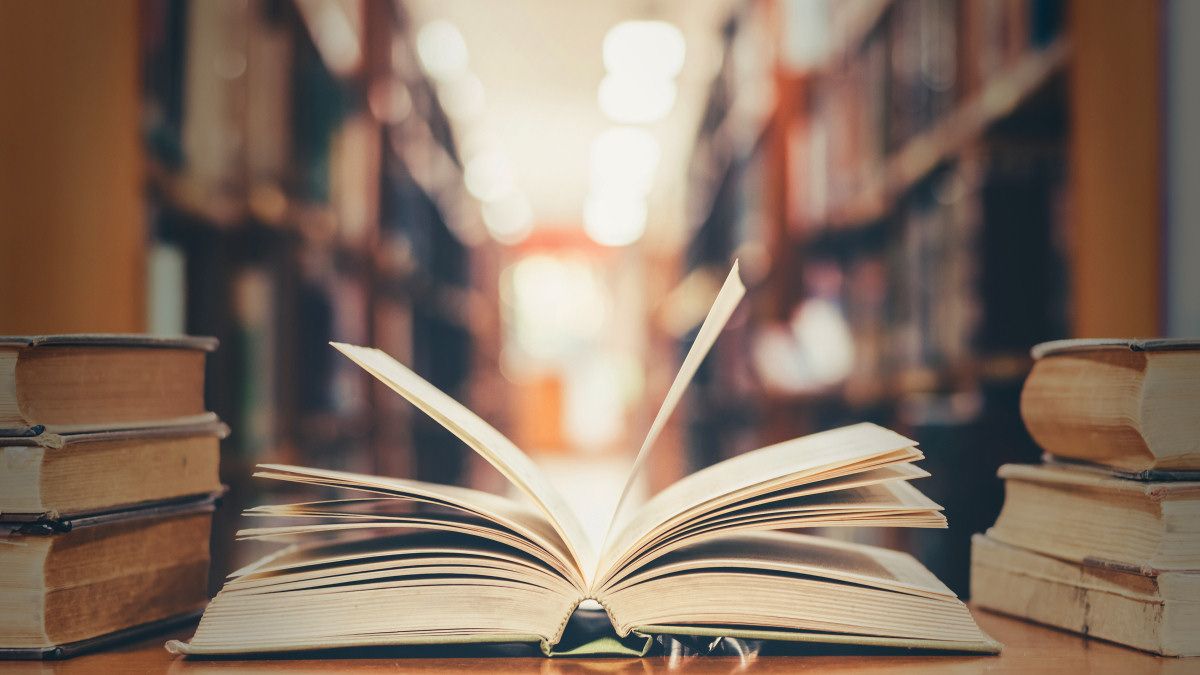 An open book on a desk in a library