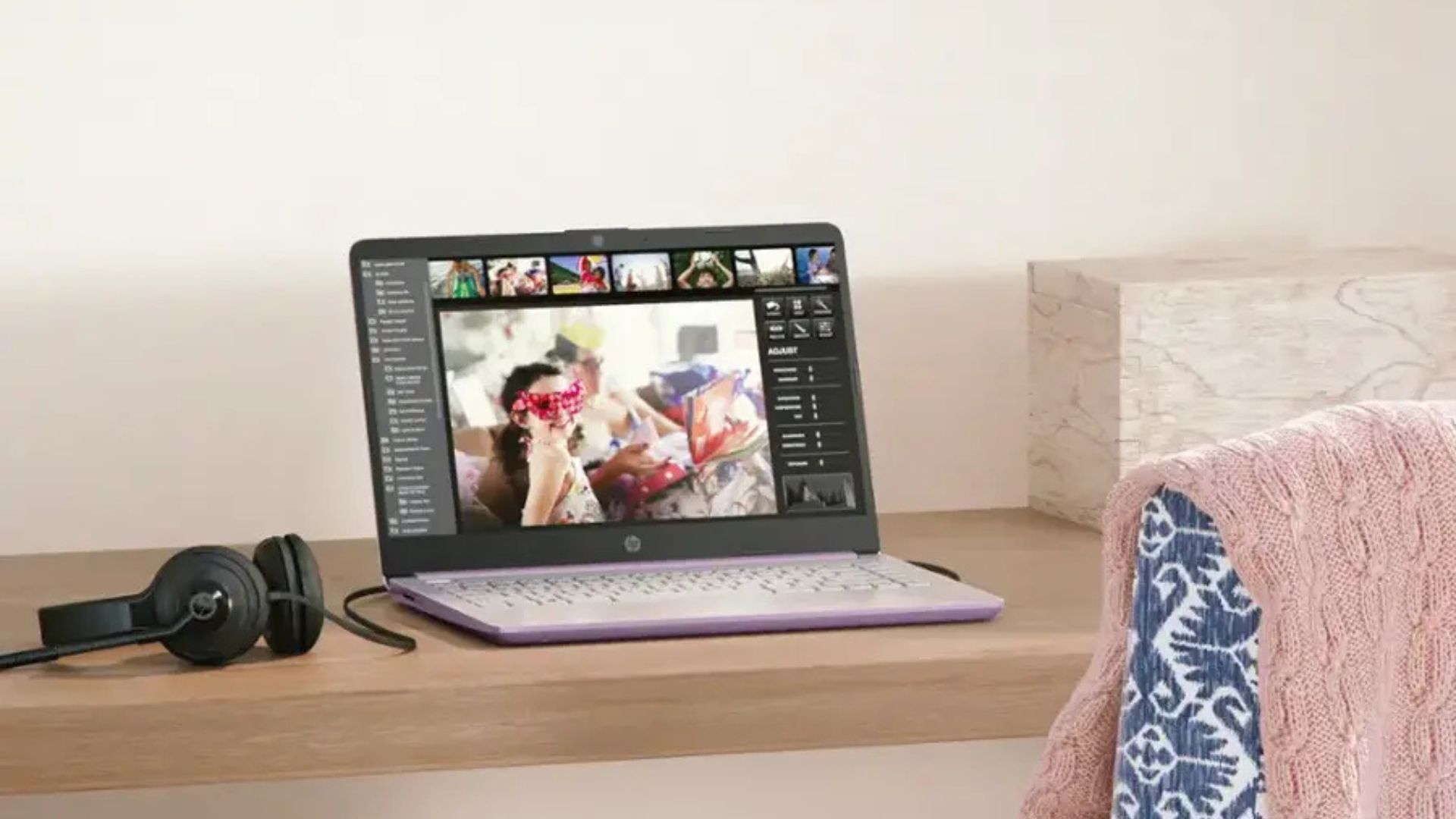 HP 14 inch laptop on a desk, with photo editing software open.