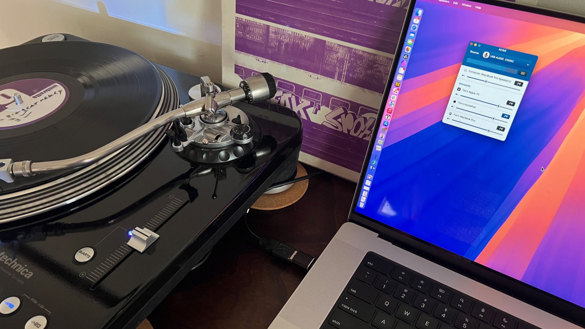 MacBook Pro and turntable playing an LP.