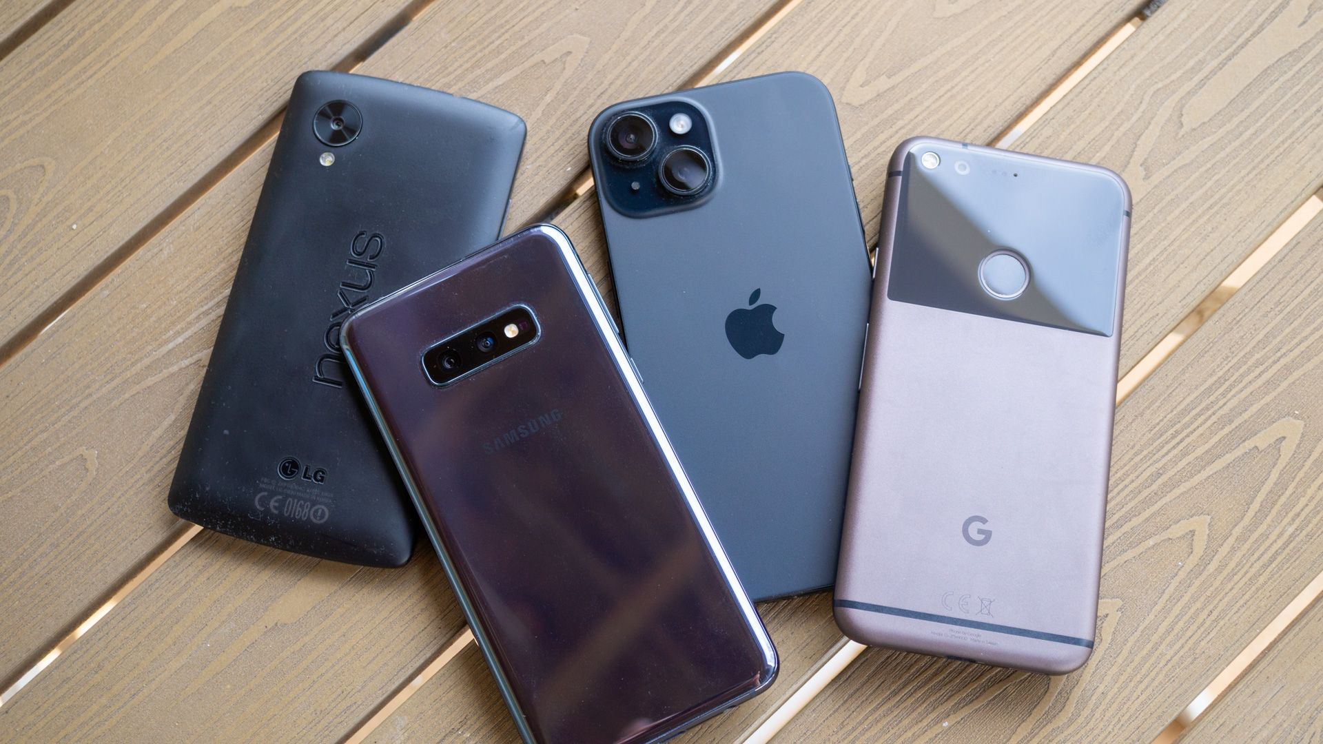 Nexus 5, Galaxy S10e, iPhone 15, and Google Pixel on a table