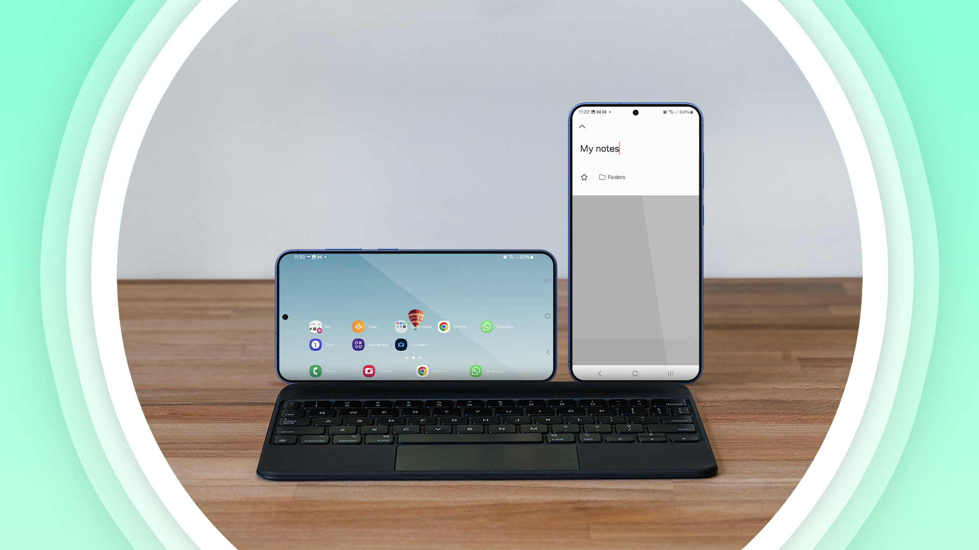 Two smartphones connected to a keyboard.